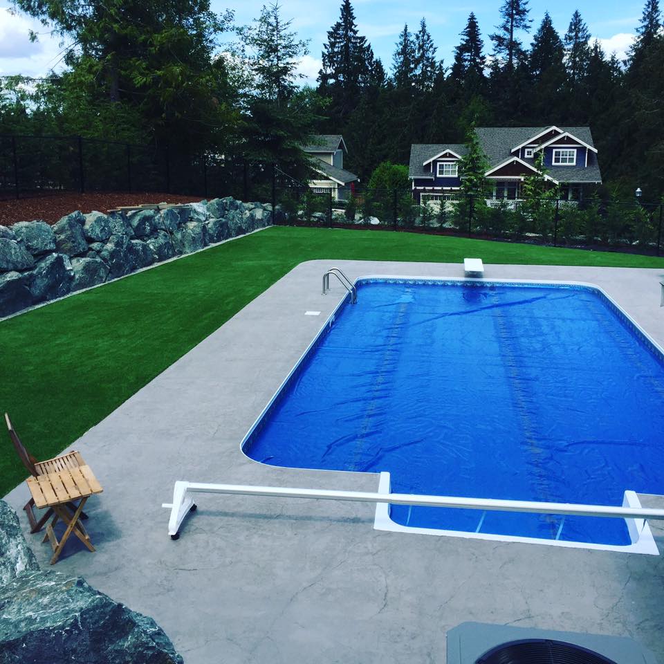 Swimming pool with artificial turf surrounding
