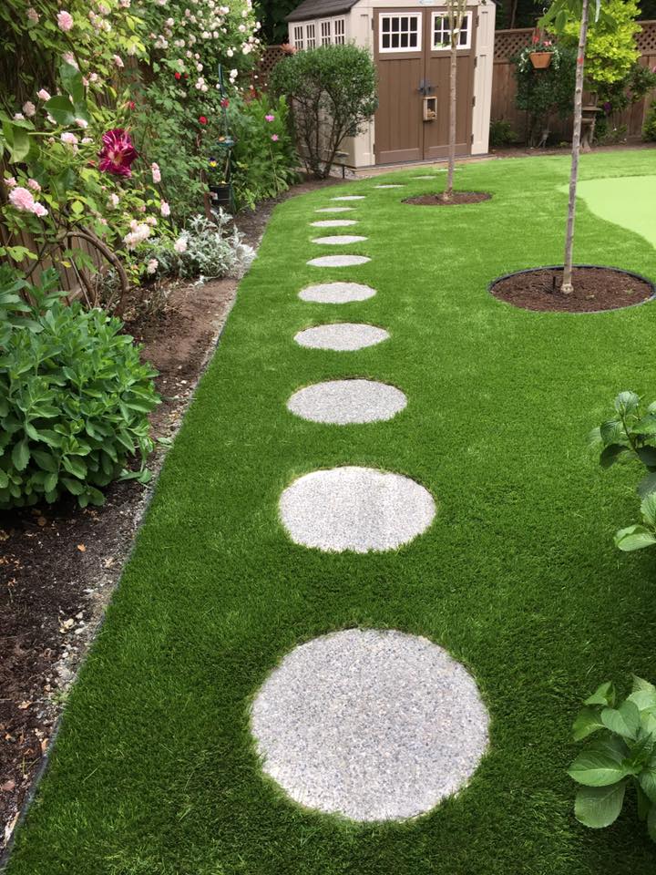 Beautiful backyard artificial grass installation in Oak Bay, Victoria featuring dense green turf