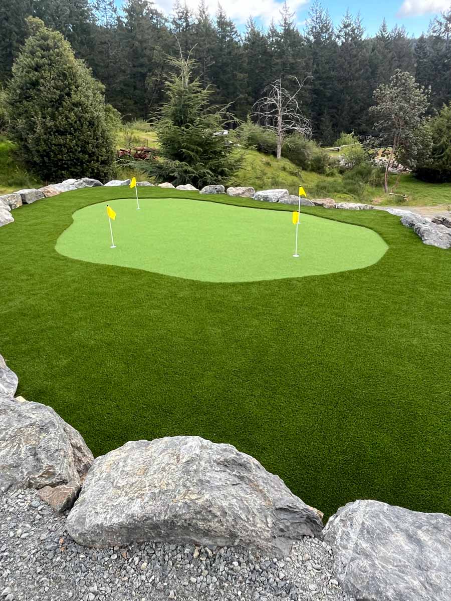 Artificial putting green surrounded by rocks