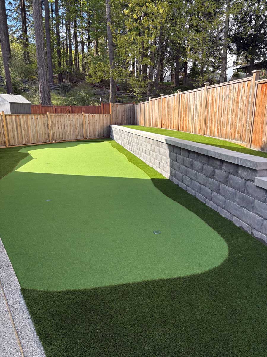 Artificial grass lawn with stone wall